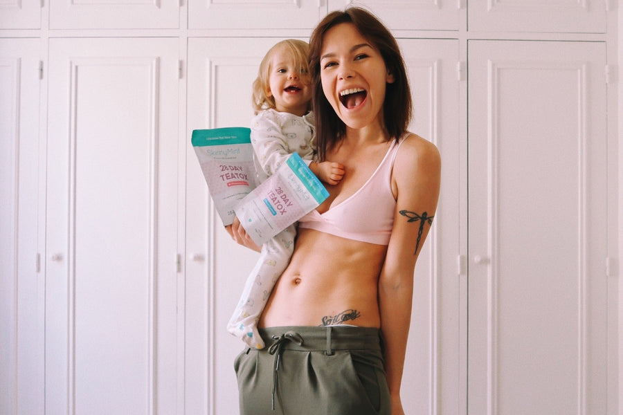 Mother and baby holding SkinnyMint 28 Dat Teatox.